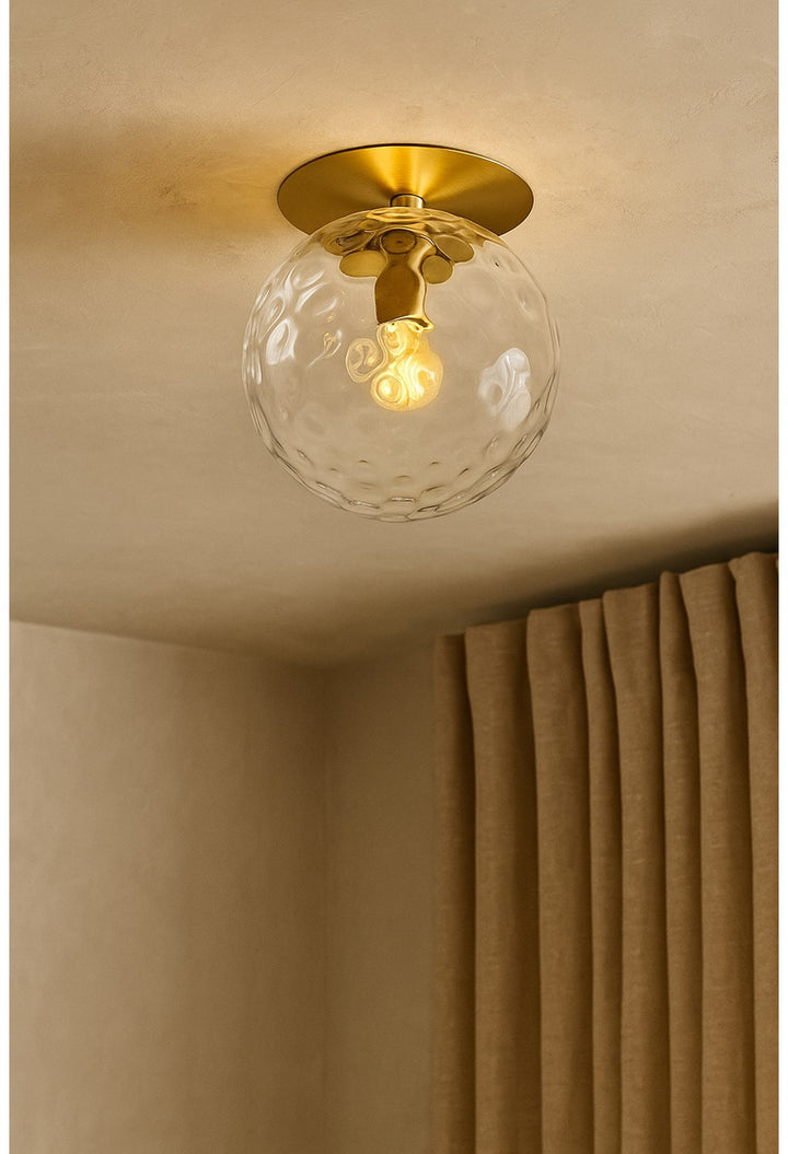 1 Light Aged Brass Incandescent Wall Sconce With Hammered Glass Globe